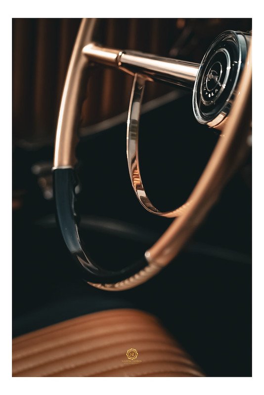 Close-up of a classic car's wooden steering wheel