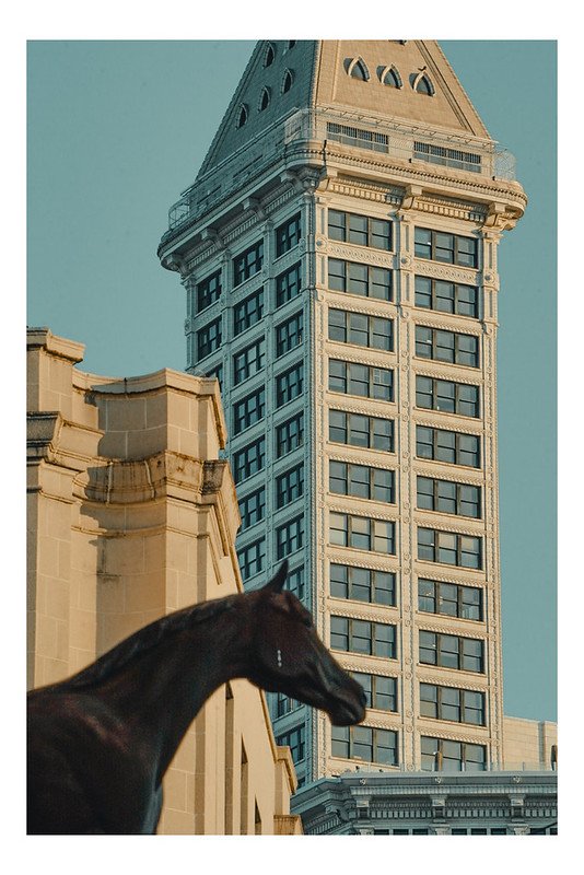 Seattle's Smith Tower with a horse statue in the foreground